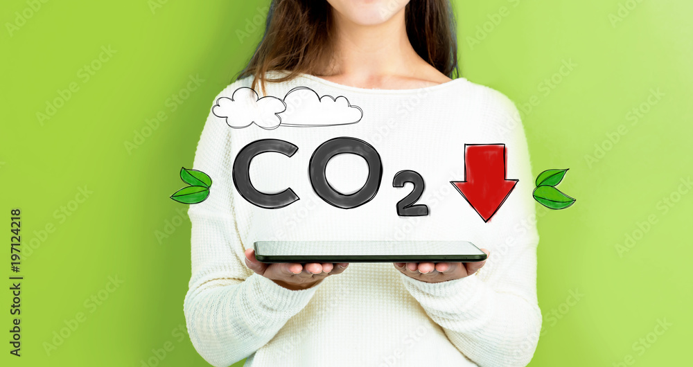 Reduce CO2 with woman holding a tablet computer