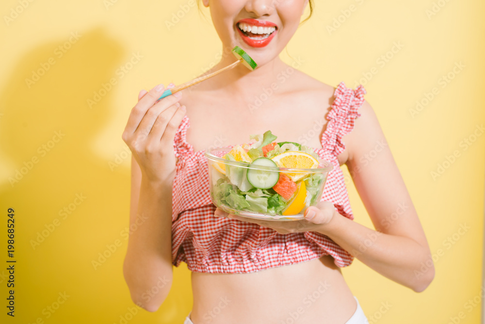 Elegant pretty slim woman eating healthy salad