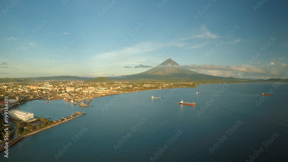 Aerial panorama of the city of Legaspi in the morning at dawn. Against the backdrop of the Mayon vol