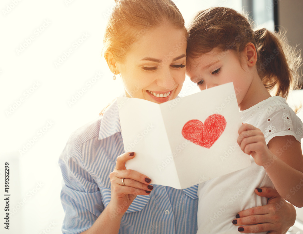 Happy mothers day! Child daughter congratulates moms and gives her a postcard