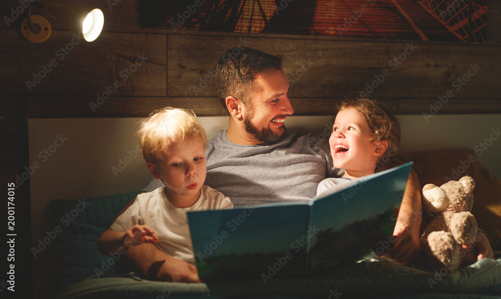 晚间家庭阅读。父亲阅读孩子。睡前读书