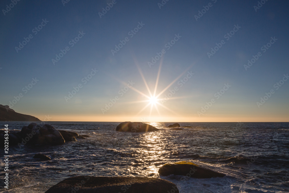 Sunset over the water with rocks