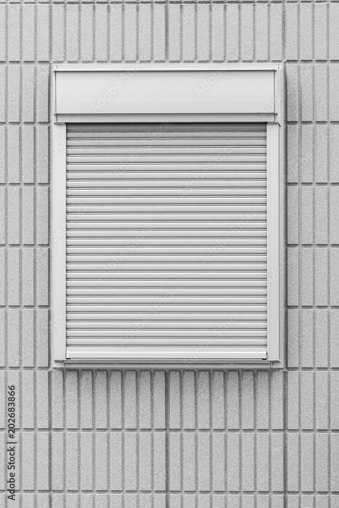 White metal shutter window and white brick wall background