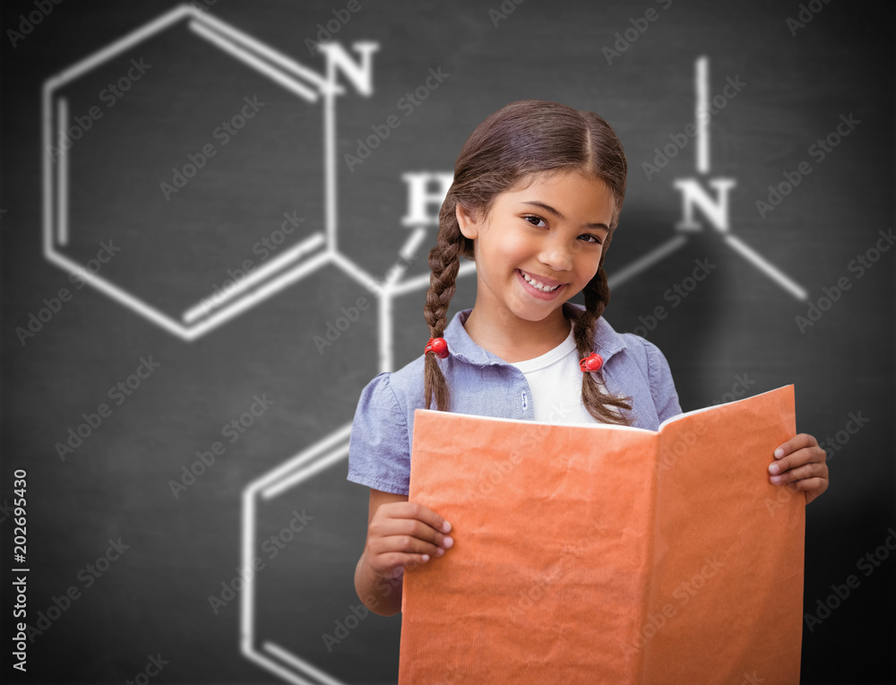 Cute pupil smiling at camera during class presentation against black background
