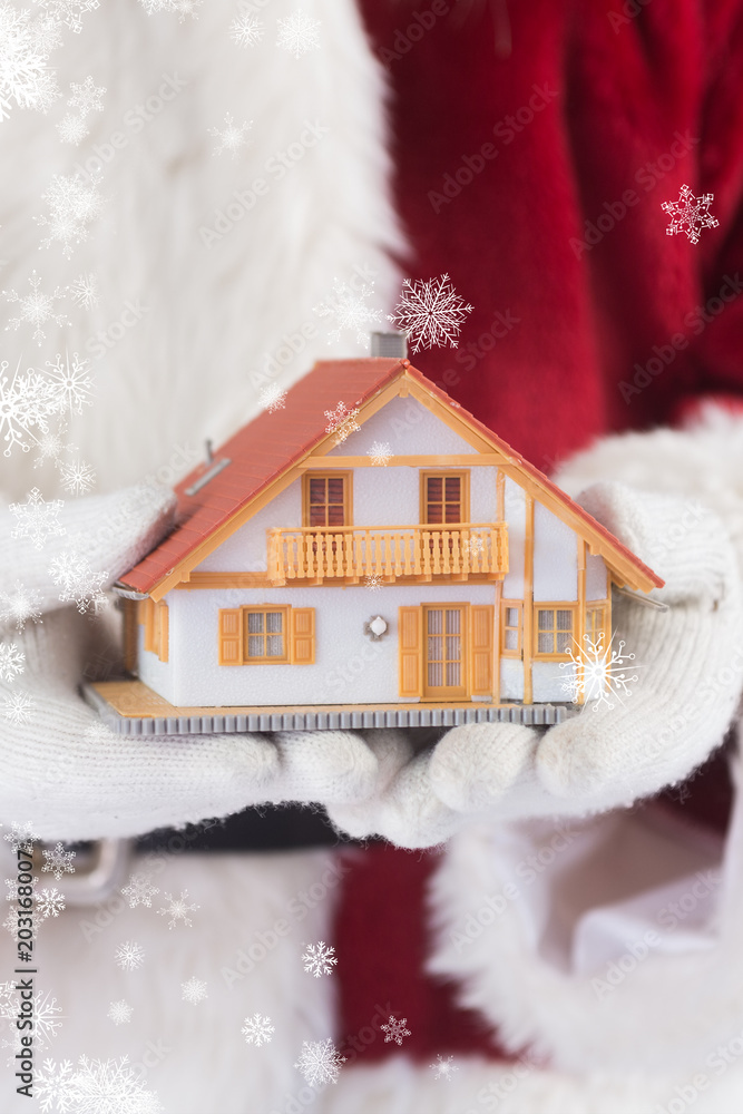 圣诞老人手里拿着一座小房子对抗蓝色