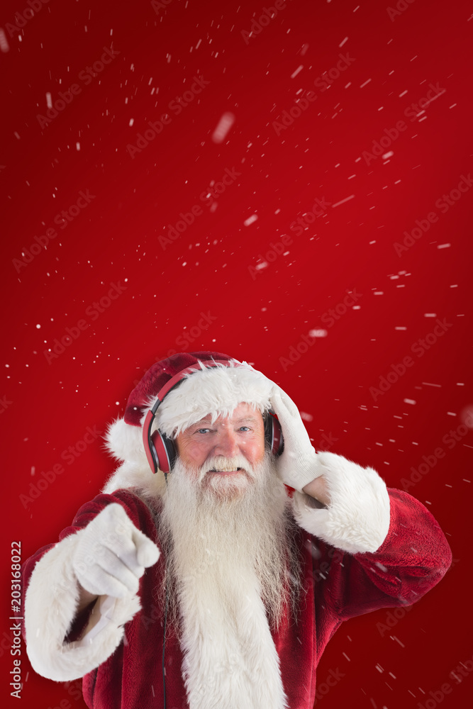 Santa is listening some music against red background