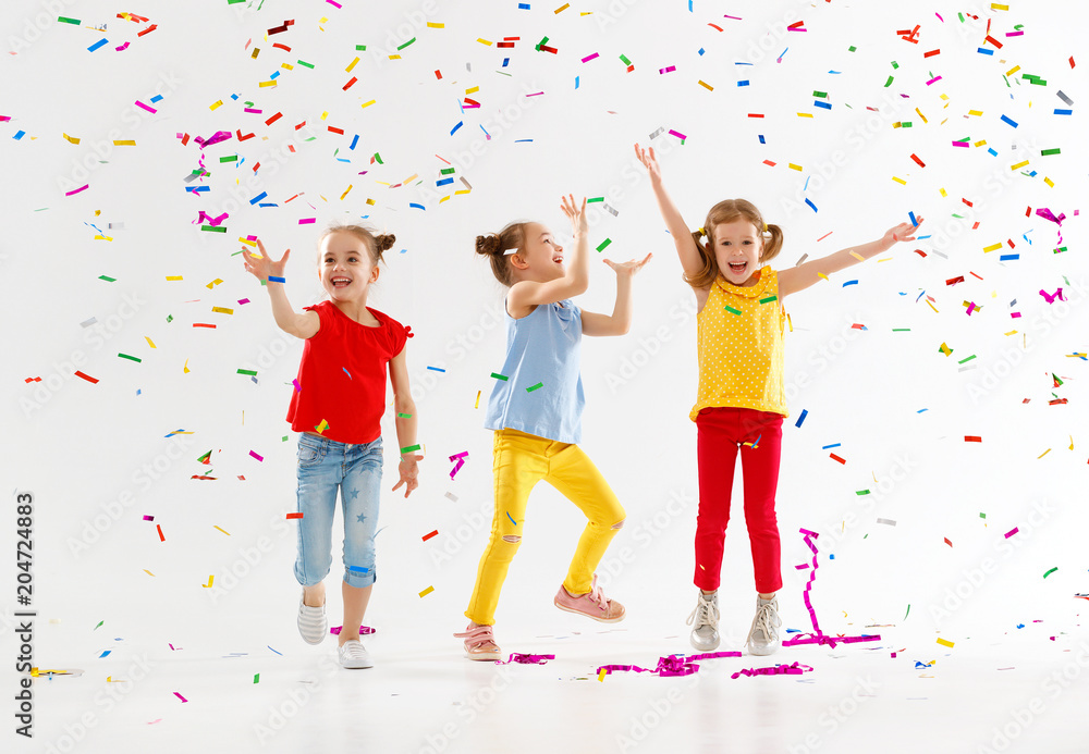 节日快乐的孩子们在白色五彩纸屑中跳跃