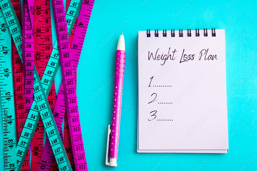 Weight loss and Diet control concept background. Colorful of a Measuring tape on vibrant blue color 