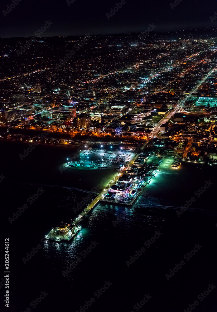 Aerial view of the Santa Monica shoreline, amusment park and pier at night