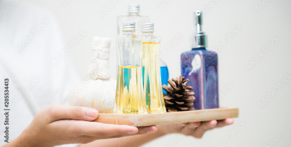 Woman holding spa treatment set in the spa.
