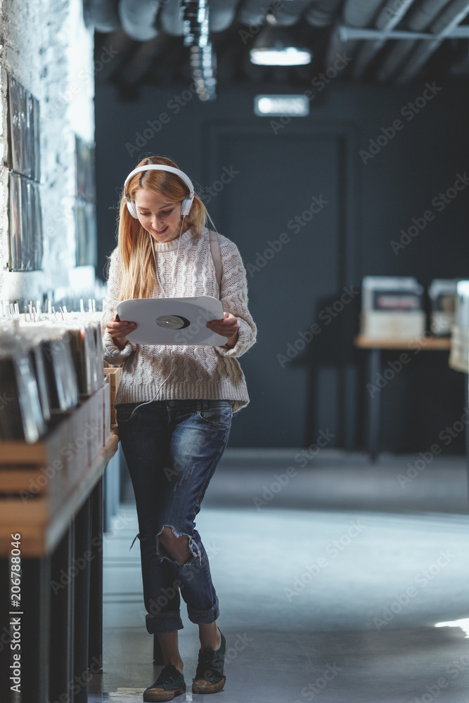 Young attractive girl in a music store