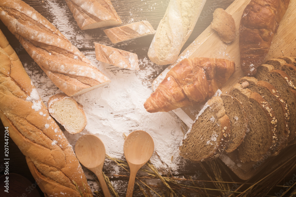 深色木桌上的新鲜烤面包，复制空间背景，小麦f静物构图