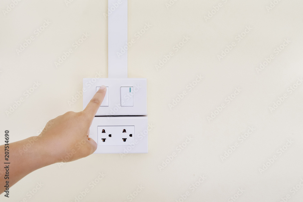 hand turning on or off light switch
