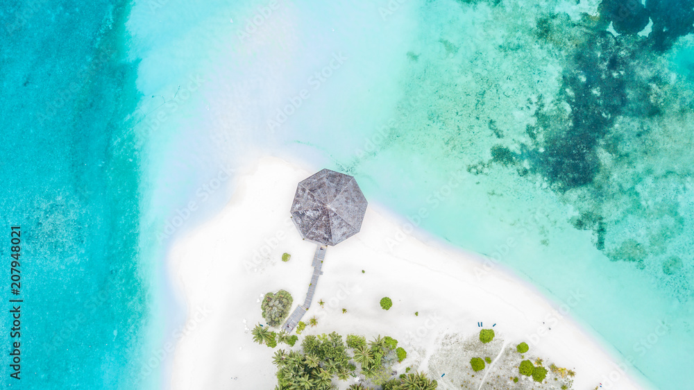 Aerial top view tropical island white sand beach with blue lagoon in Maldives island, Beautiful trop