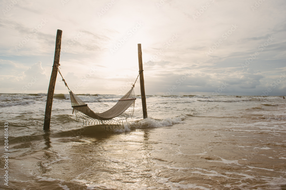 sandy beach with hammock, sunset at beautiful adventure beach