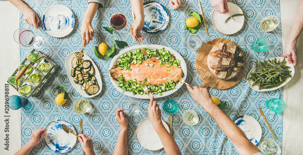 Family or friends summer party or seafood dinner. Flat-lay of group of mutinational people with diff