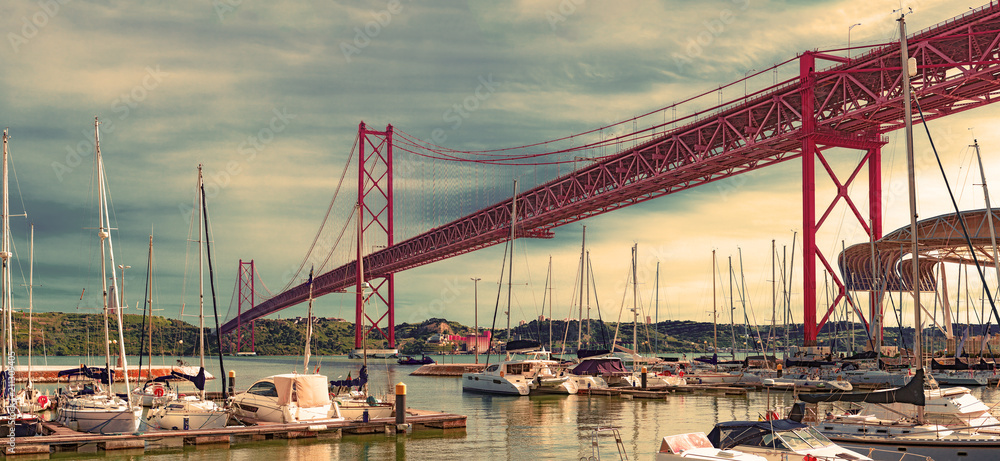 Bridge of April 25 in Lisbon.Cityscape of Lisbon and seaport. Entertainment and leisure in Portugal.