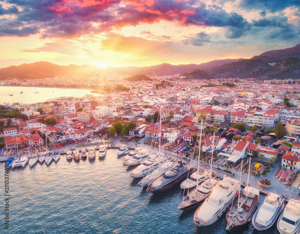 Aerial view of boats and yachts and beautiful city at sunset in Marmaris, Turkey. Landscape with boa