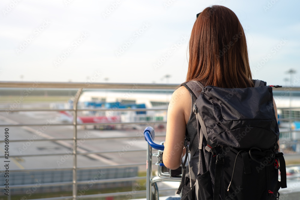 之前在登机口等待时，站在机场码头看飞机的旅游游客