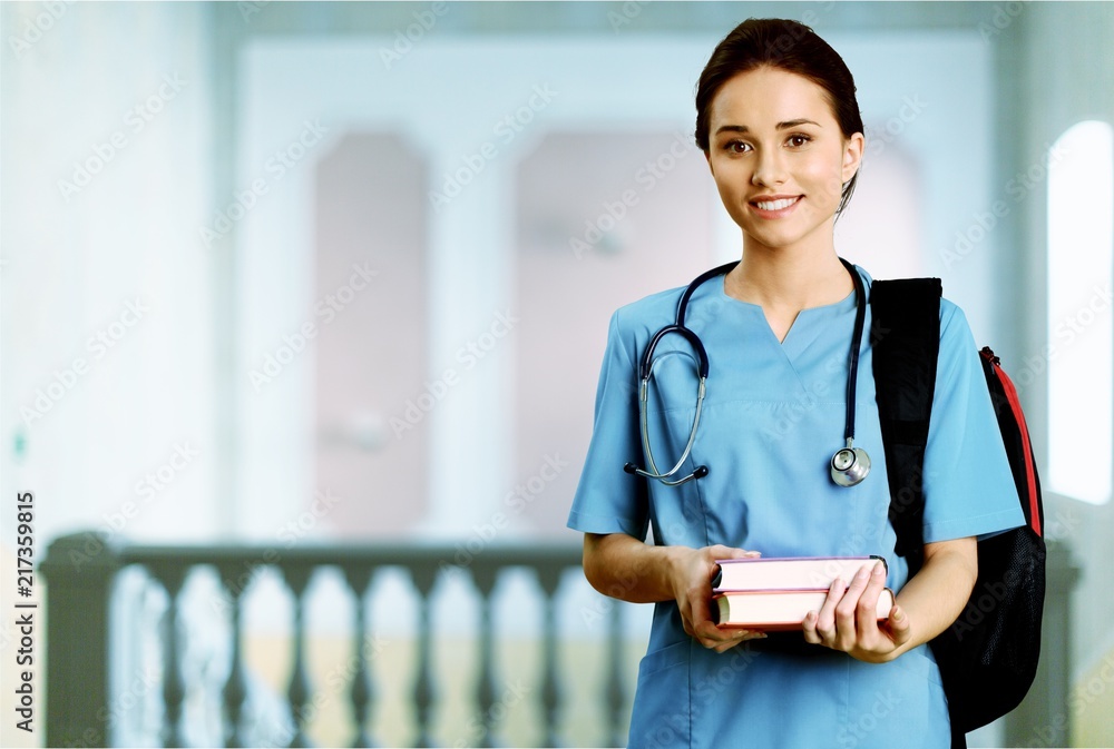 Nurse student with books and stethoscope in