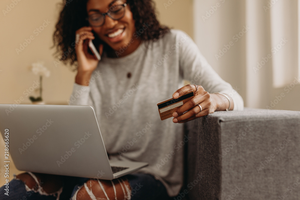 Woman talking over mobile phone while working from home