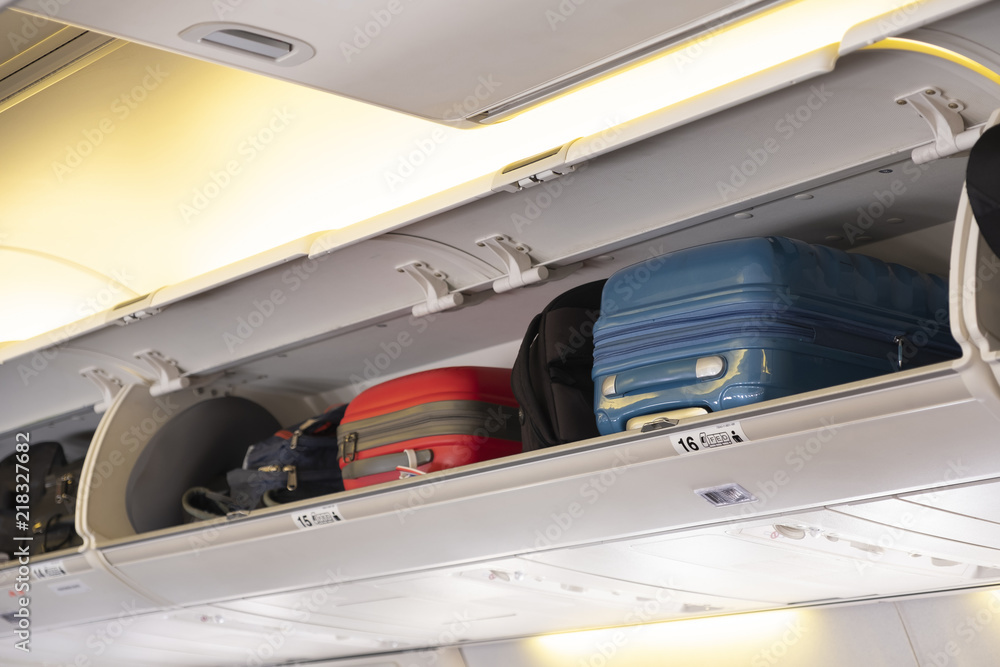 Carry-on luggage on the top shelf in airplane