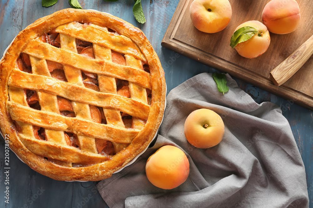 Delicious peach pie on wooden table