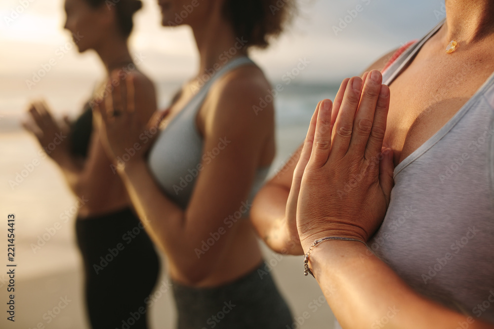 站在海滩上练习瑜伽的健身女性