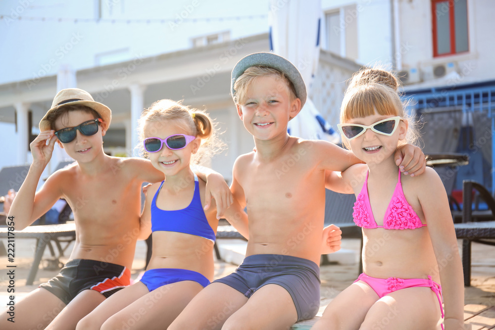 Cute children near swimming pool on summer day