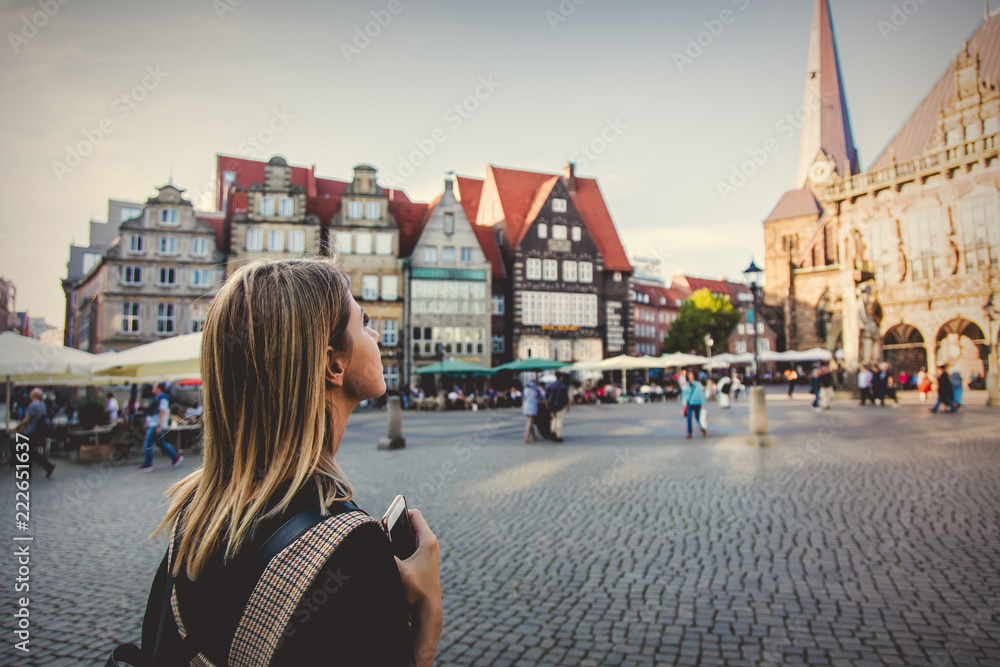 Young lady in dress on medieval street of Bremen, Germany. Trevel destination concept