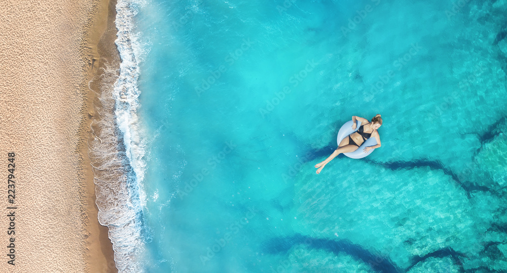 Aerial view at the girl on sea. Turquoise water from air as a background from air. Natural seascape 