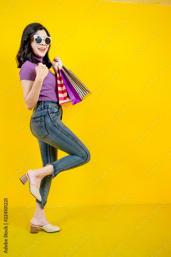 Shopping Woman concept, portrait or isolated an beautiful Asian woman wearing dress, hat and sunglas
