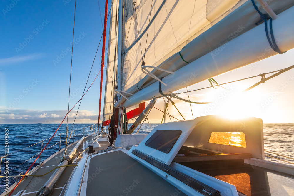 在帆船游艇上航行，德雷克航道有美丽的日落，晴朗的蓝天和平坦的大海。