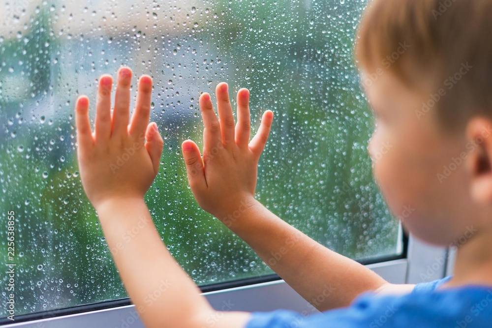 Boy at the rainy window
