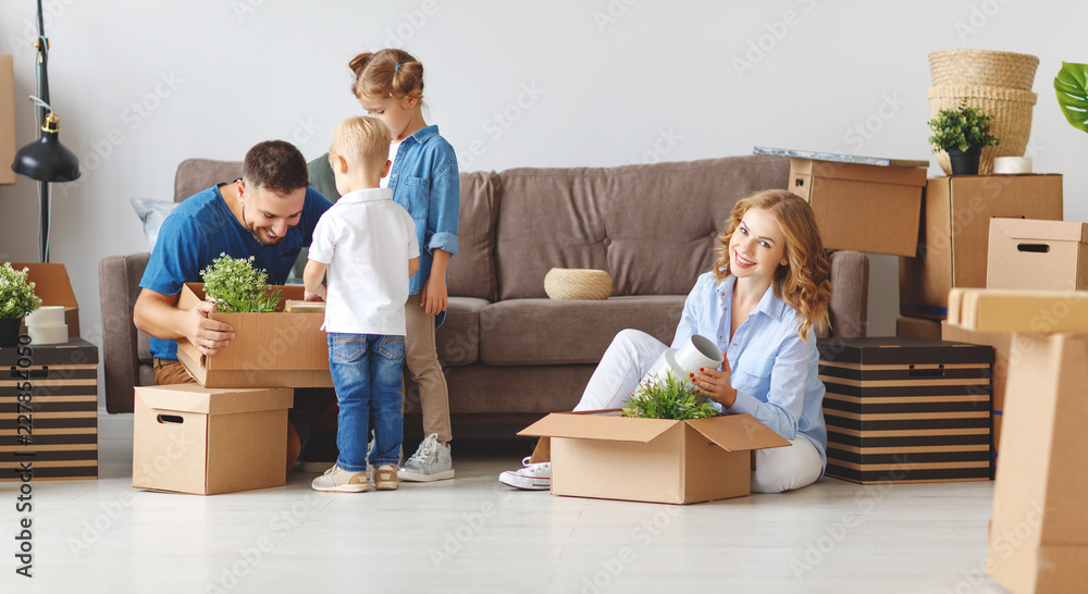 幸福家庭的母亲、父亲和孩子搬到新公寓，打开箱子。