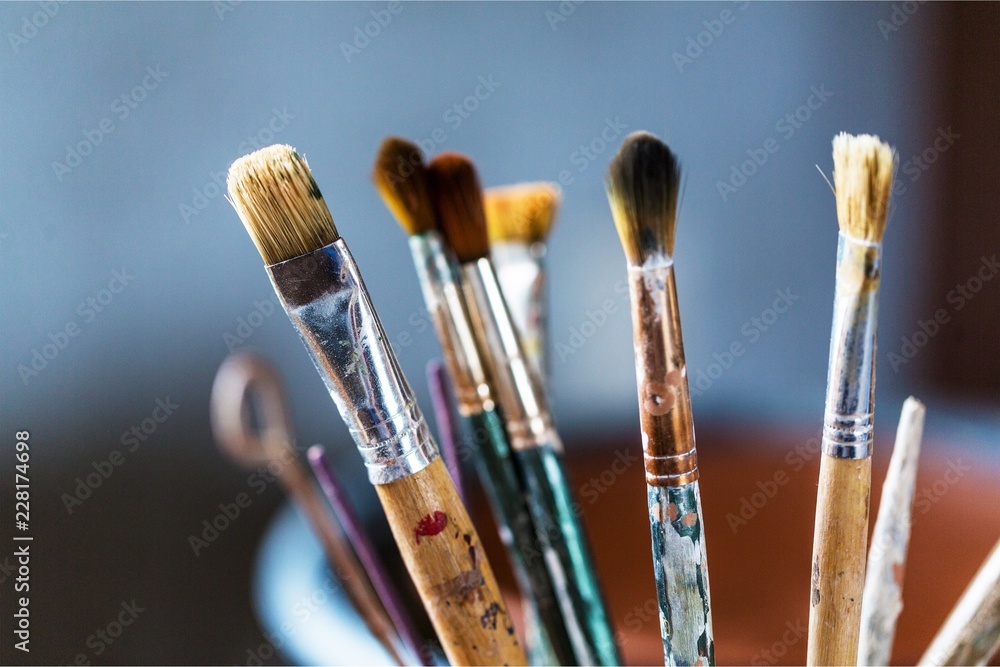 Artist paint brushes and paint cans