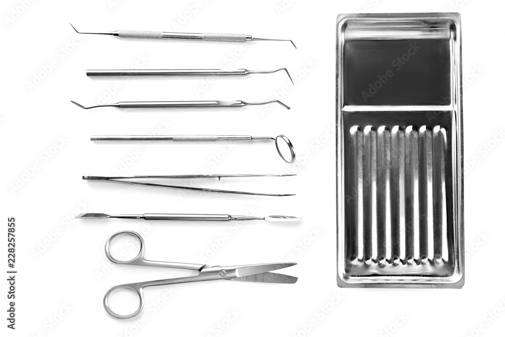 白底牙医工具和金属托盘