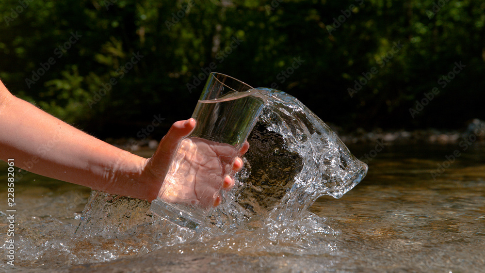 CLOSE UP: Unrecognizable woman scoops up cold spring water into an empty glass