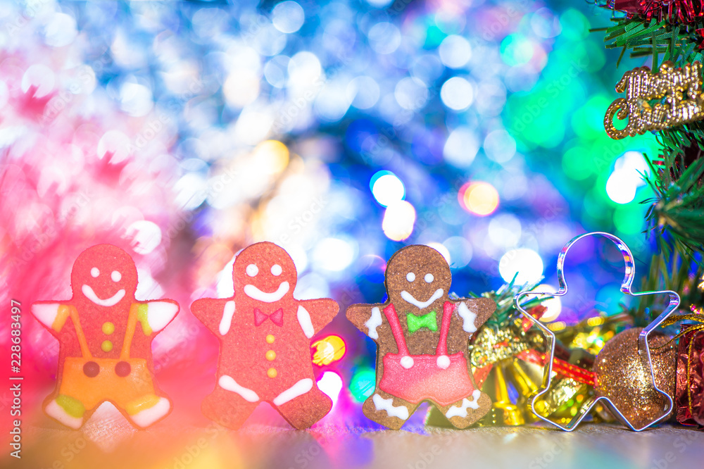 Cute gingerbread man with christmas tree and blurry sparkle background, close up, bokeh, text space(