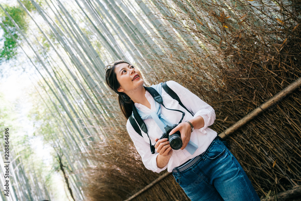 photographer standing next to the bamboo forest