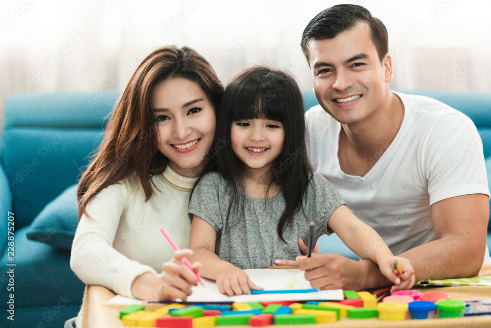 可爱的黑发孩子女女儿在客厅c与家长一起做作业和欢笑