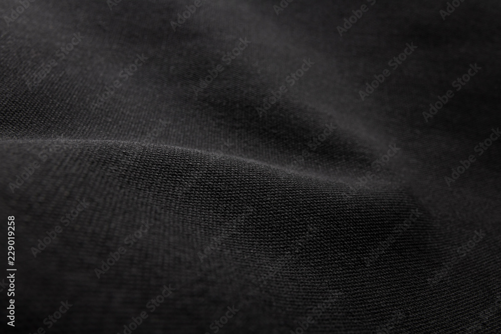黑色织物纹理背景。帆布纺织材料细节。