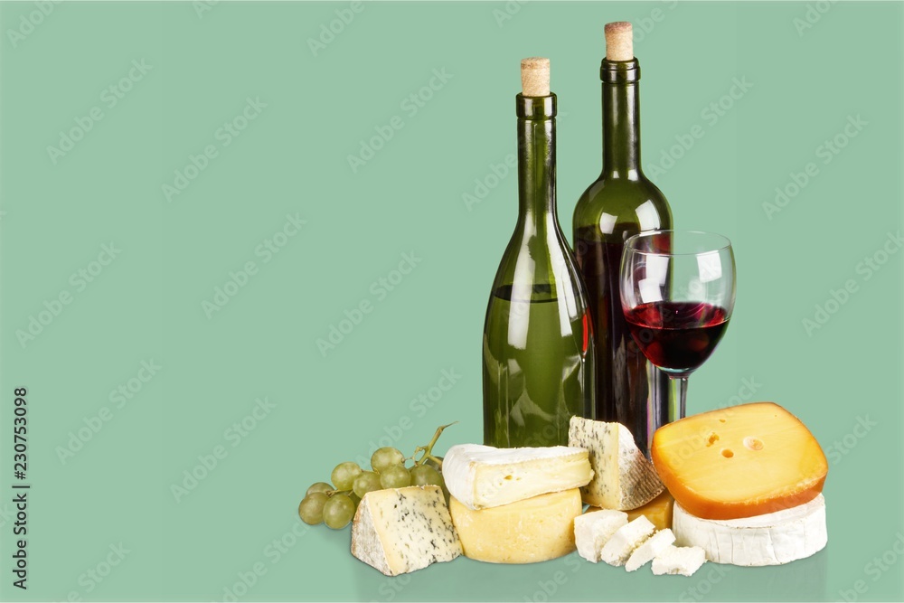 Assortment of cheese on board and two