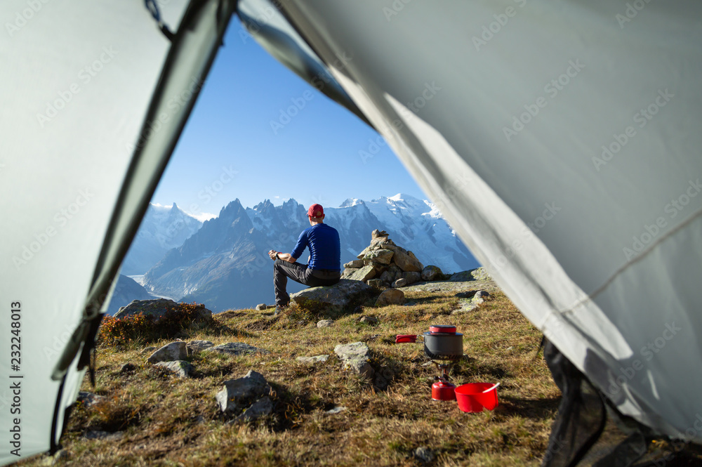 徒步旅行者在山上的露营地欣赏风景，喝一杯咖啡。