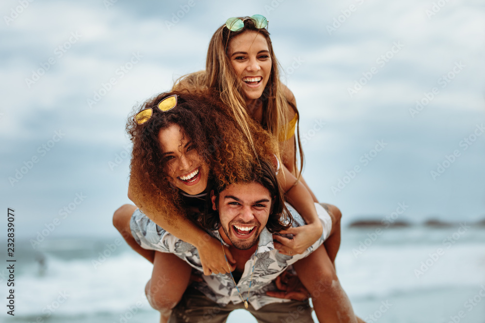 Multi-ethnic friends enjoying summer holidays on beach