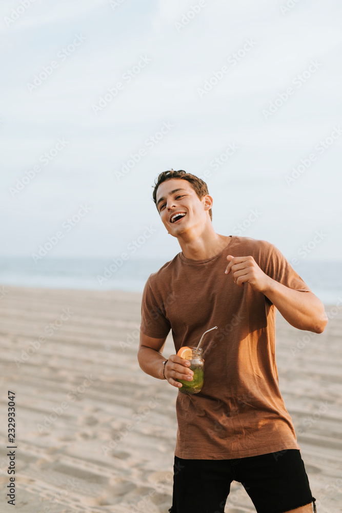 Man drinking a mojito at a beach party