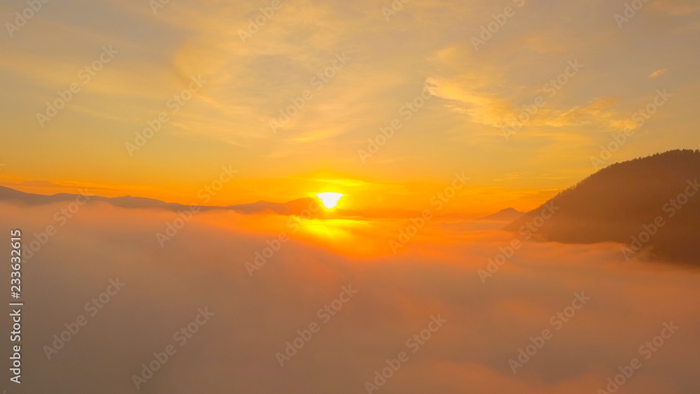 航空：美丽的金色日落太阳落在薄雾之上
