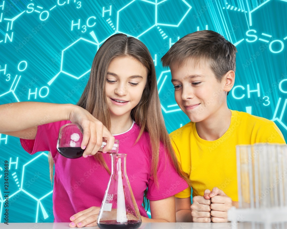 Boy and girl doing chemical experiment. pouring liquid into