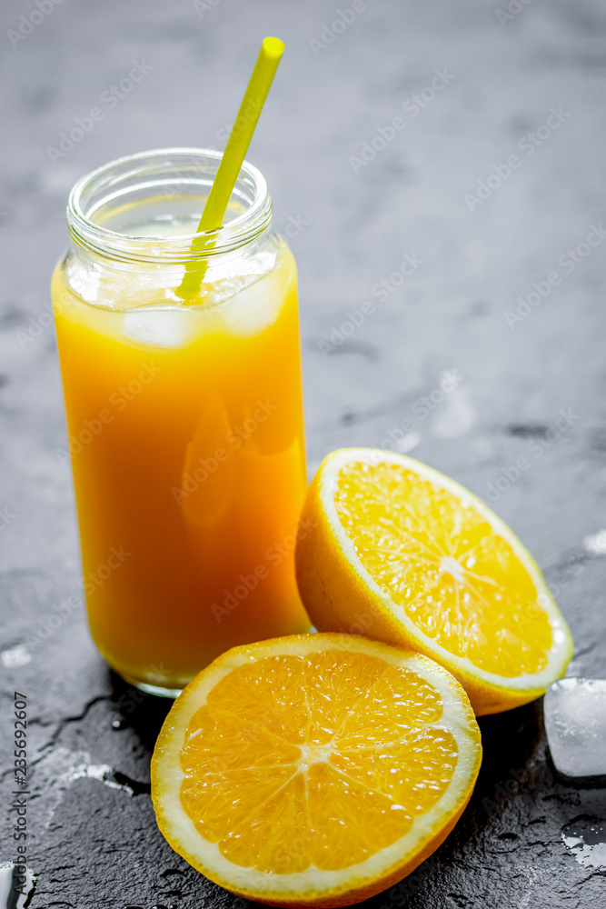 freshly squeezed orange juice on dark background