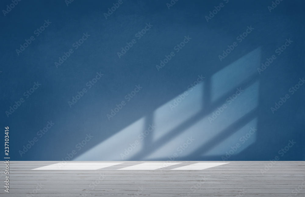 Blue wall in an empty room with concrete floor